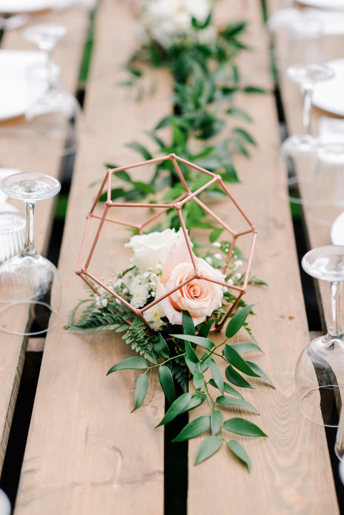 soft table decor on these wood harvest tables with a copper flower holder. https://www.thegathered.ca