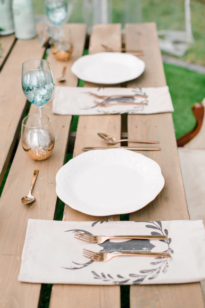 rustic place setting with contrasting gold flatware on this wood harvest table. https://www.thegathered.ca