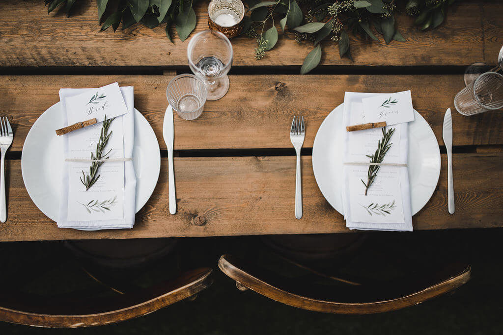 Place setting complete with customized Menu on wood harvest tables
