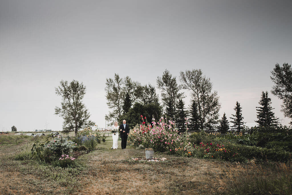 Outdoor wedding ceremony with a garden backdrop