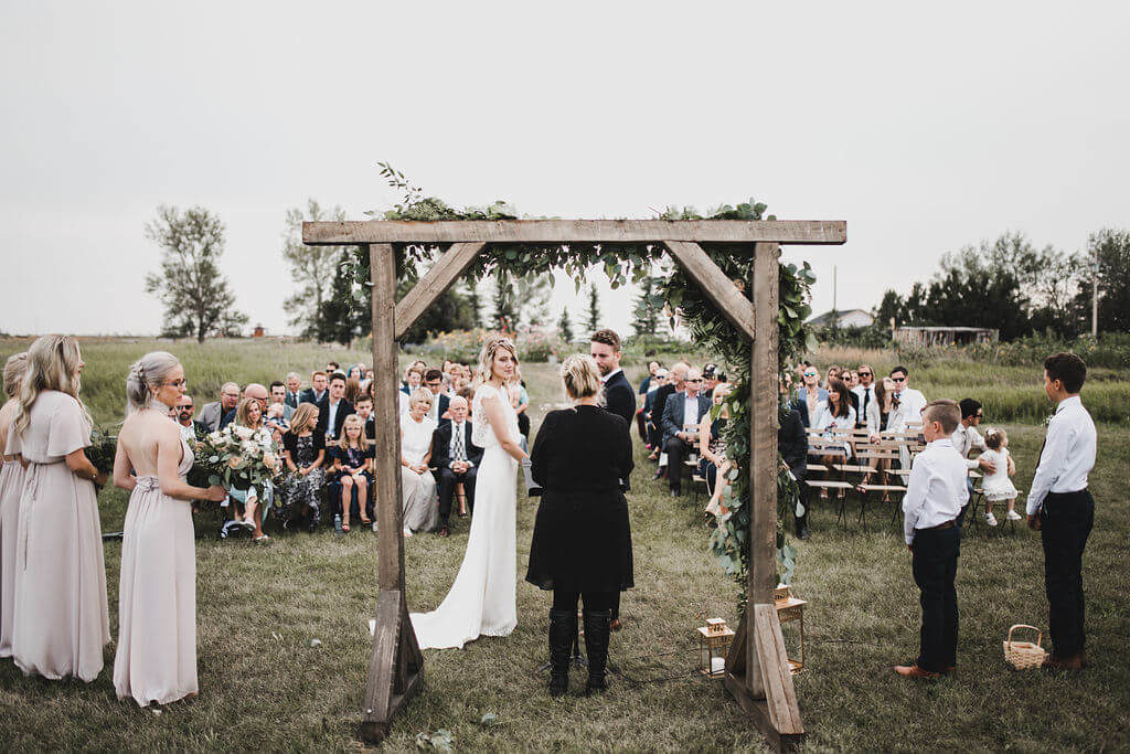 outdoor wedding ceremony with  wood arch https://www.thegathered.ca