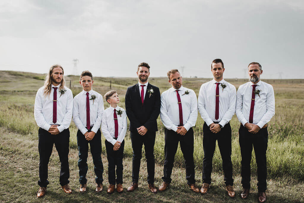 Groomsmen suits with white shirts and red ties, perfect for a laid back vibe for a wedding! https://www.thegathered.c