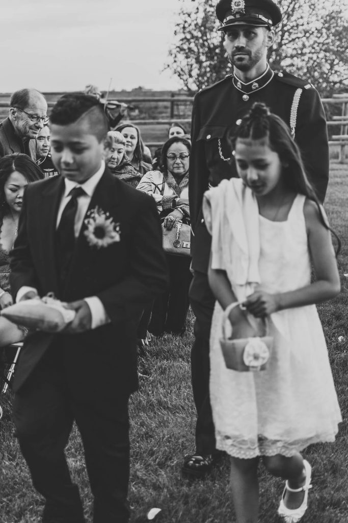 flower girl and ring bearer walking down the aisle prior to the groom