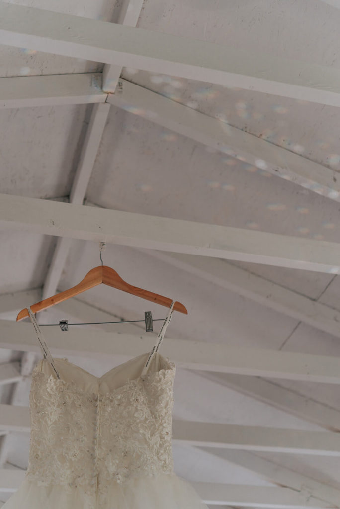 wedding dress hanging on the rafters of a cottage
