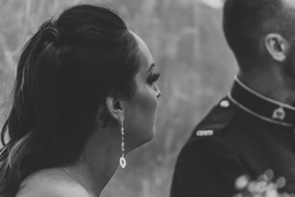 bride wearing long drop earrings staring to her left 