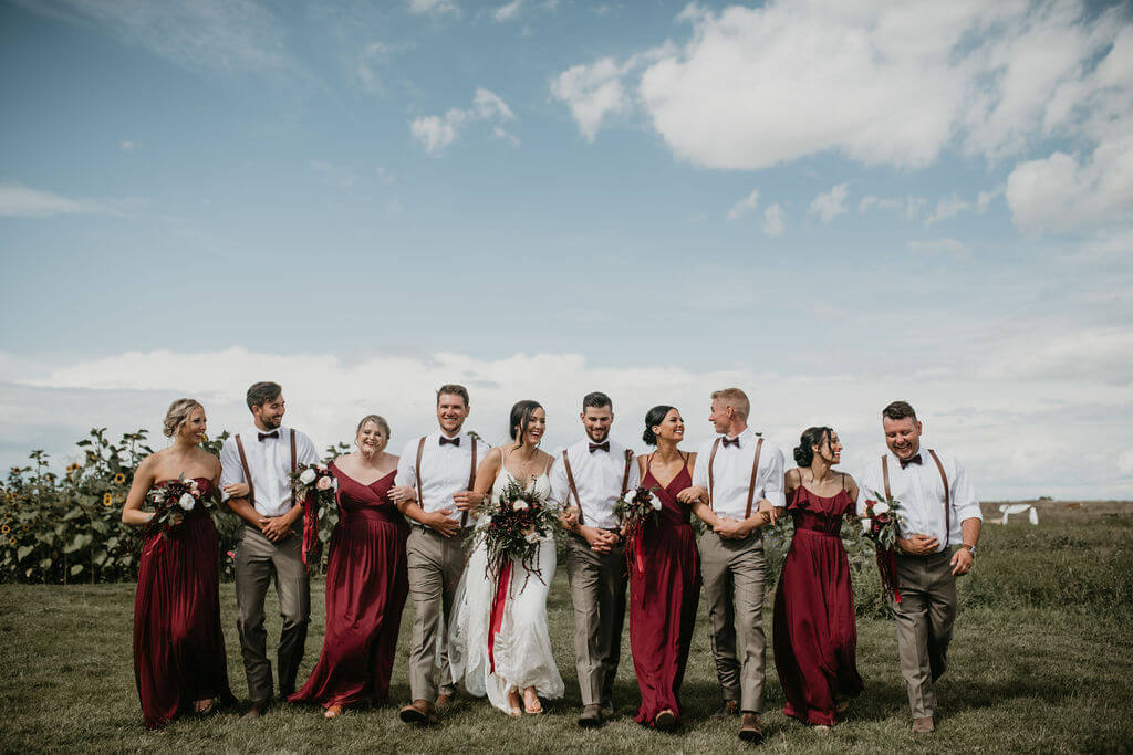bridal party, girls in red dresses and boys in leather suspenders and gray pants