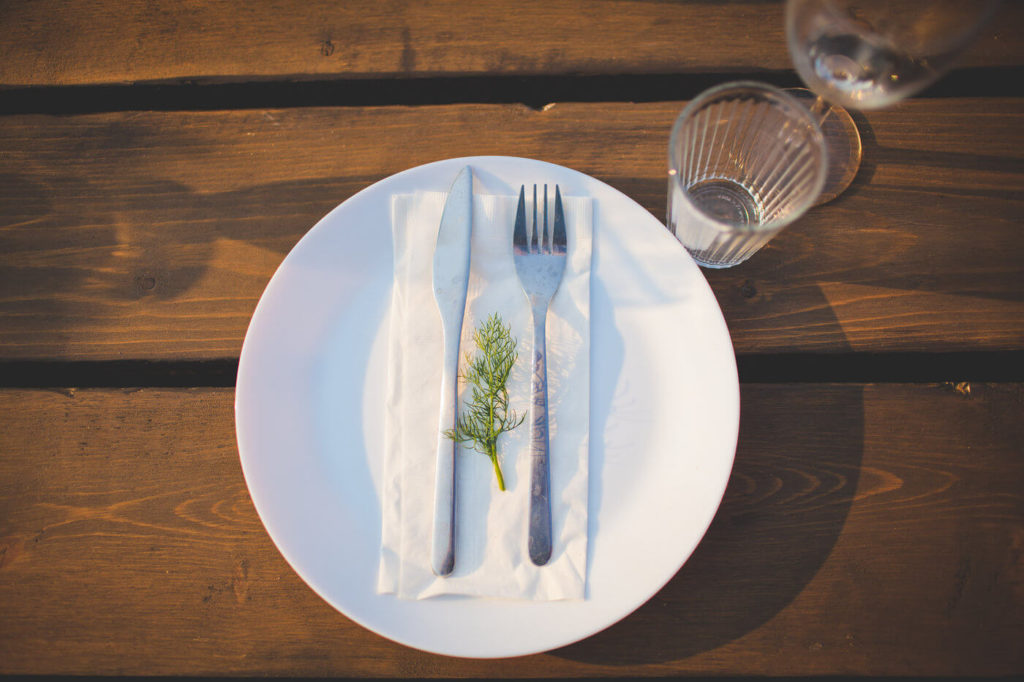 simple table setting with a white plate and cutlery 