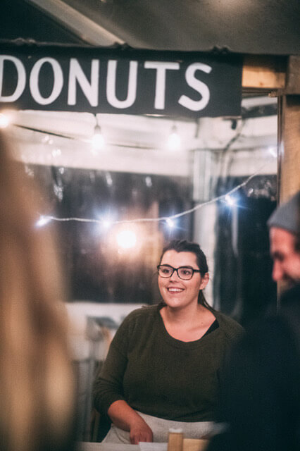 nicole handing out donuts at the donut stand