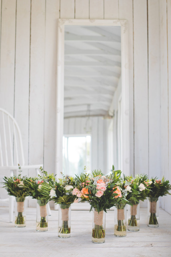 Seven Coral and Peach wedding bouquets with bright greenery in a white cottage - Vanessa and Josh and their rainy Alberta wedding day