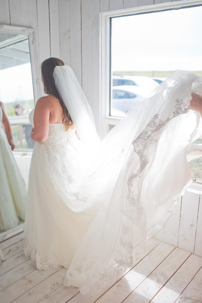 White Bridal Cottage with a brides lacy dress and long white veil - vanessa and josh - The Gathered in Calgary, Alberta