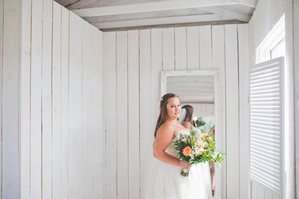 White Bridal Cottage with a brides lacy dress and long white veil, coral and peach vibrant floral bouquets - vanessa and josh - The Gathered in Calgary, Alberta
