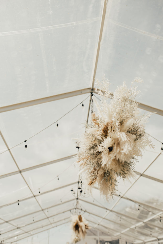 hanging pampas pieces are the perfect wedding decor to spruce up any wedding tent