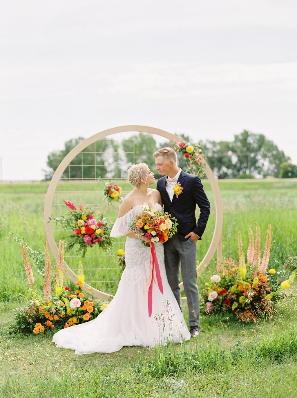 bold floral bouquet with reds, yellows and oranges make the spring colors pop with warmth and boldness for this couples spring wedding