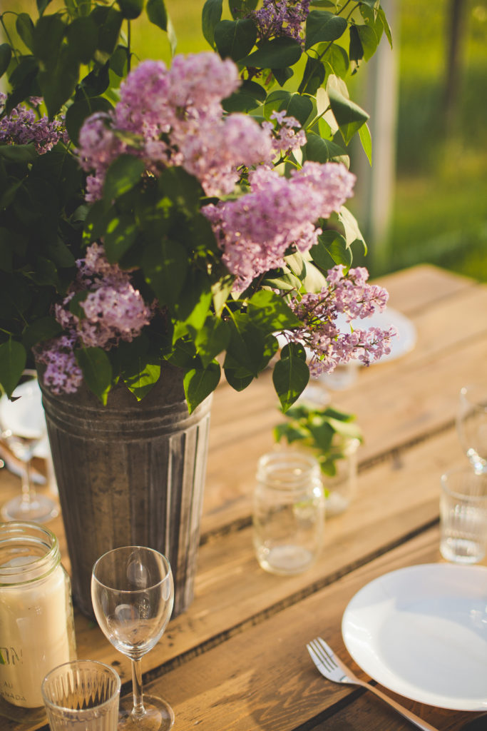 a beautiful close up shot of purple lilacs in a tin bucket makes a show stopping centrepiece www.thegathered.ca