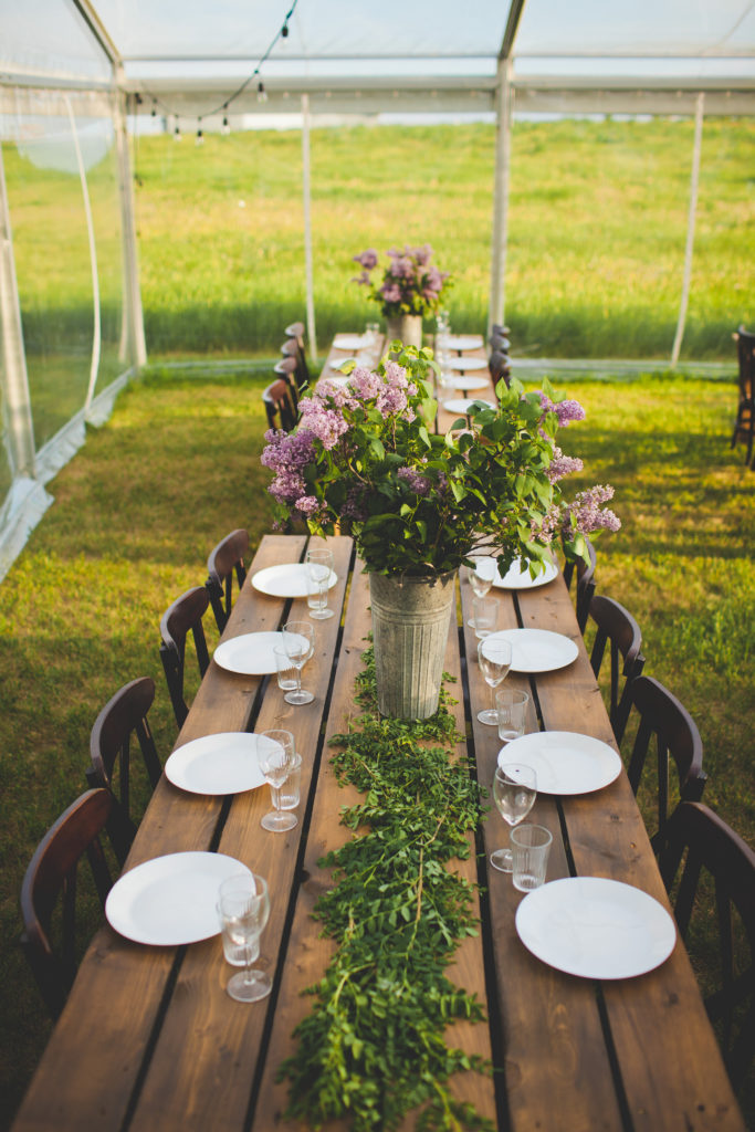 long wooden tables covered in lilac florals decorated with white plates and glassware. www.thegathered.ca