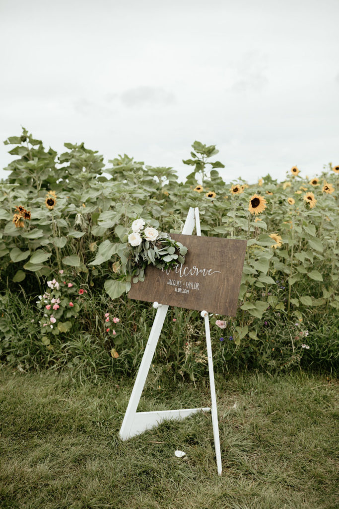 welcome wedding sign in a sunflower garden