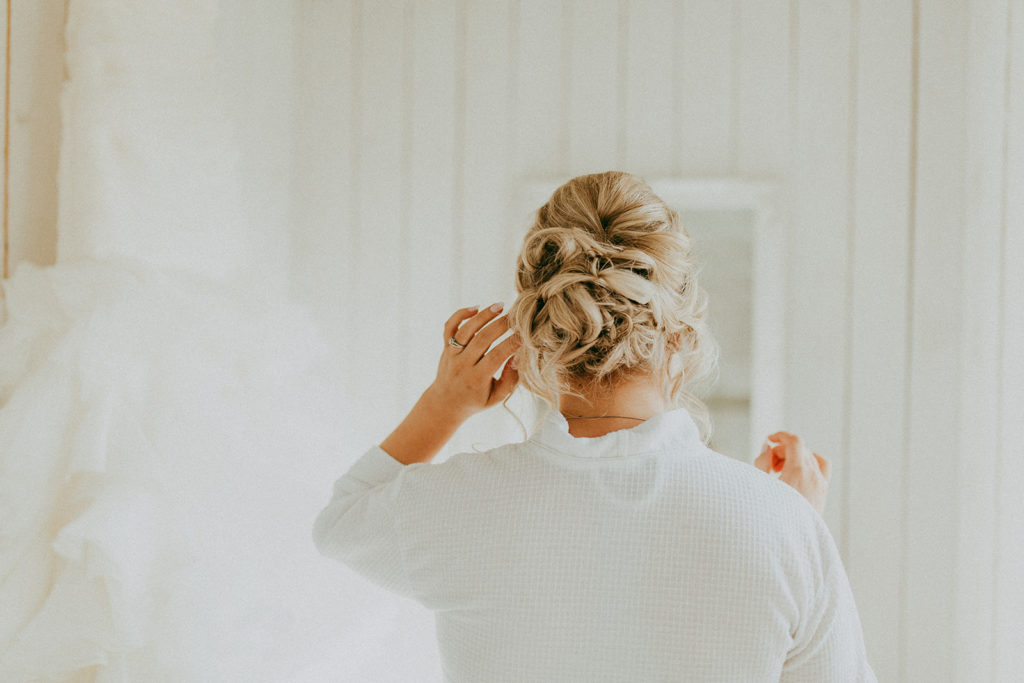 the back of a brides hair that is pined up in a beautiful updo