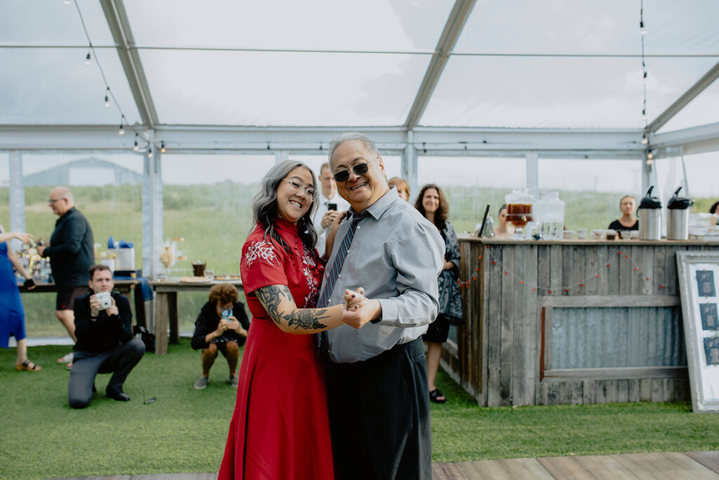 A father and daughter dancing at a wedding reception.