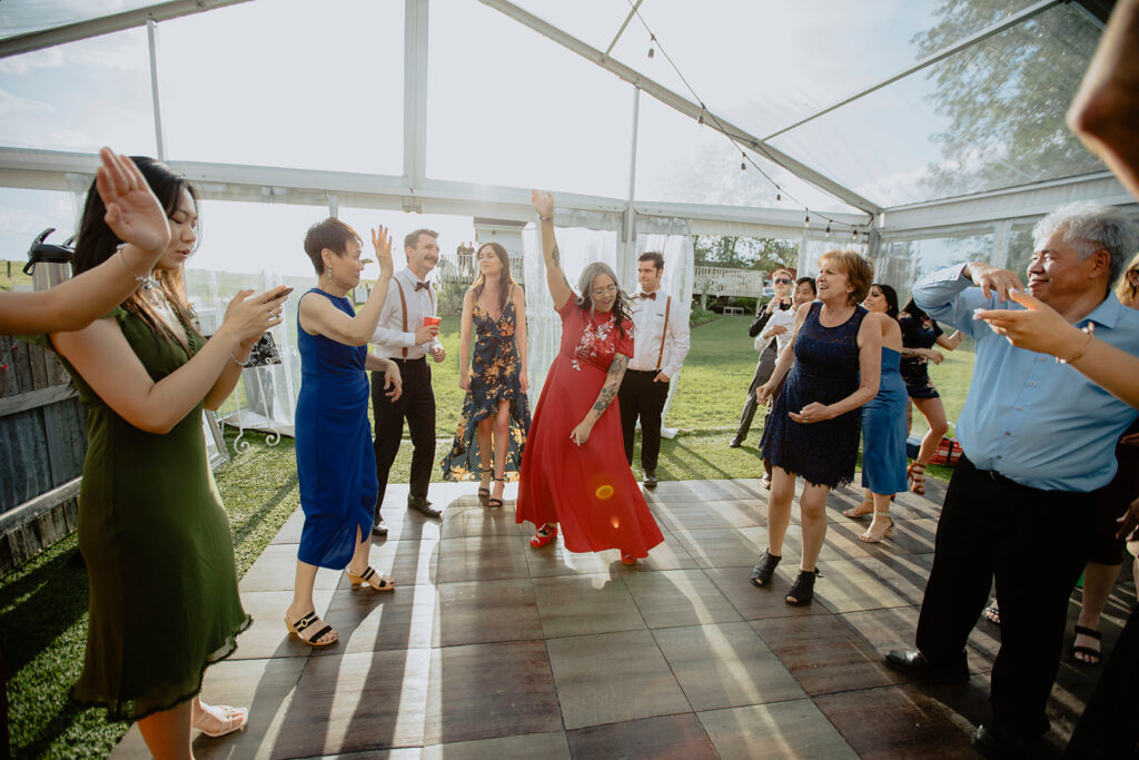 A group of people dancing in a tent.