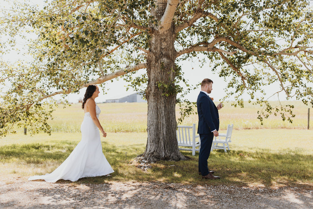 A bride and groom standing under a tree. Outdoor Dinner Party