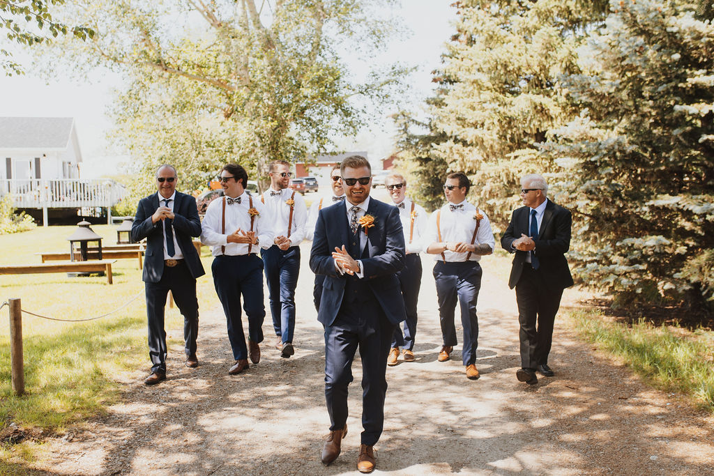 A group of groomsmen walking down a path. Outdoor Dinner Party