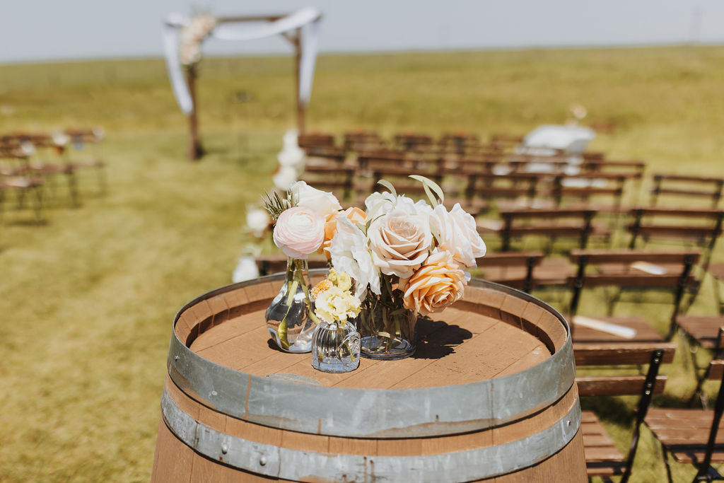 A wedding ceremony set up on a wooden barrel.
