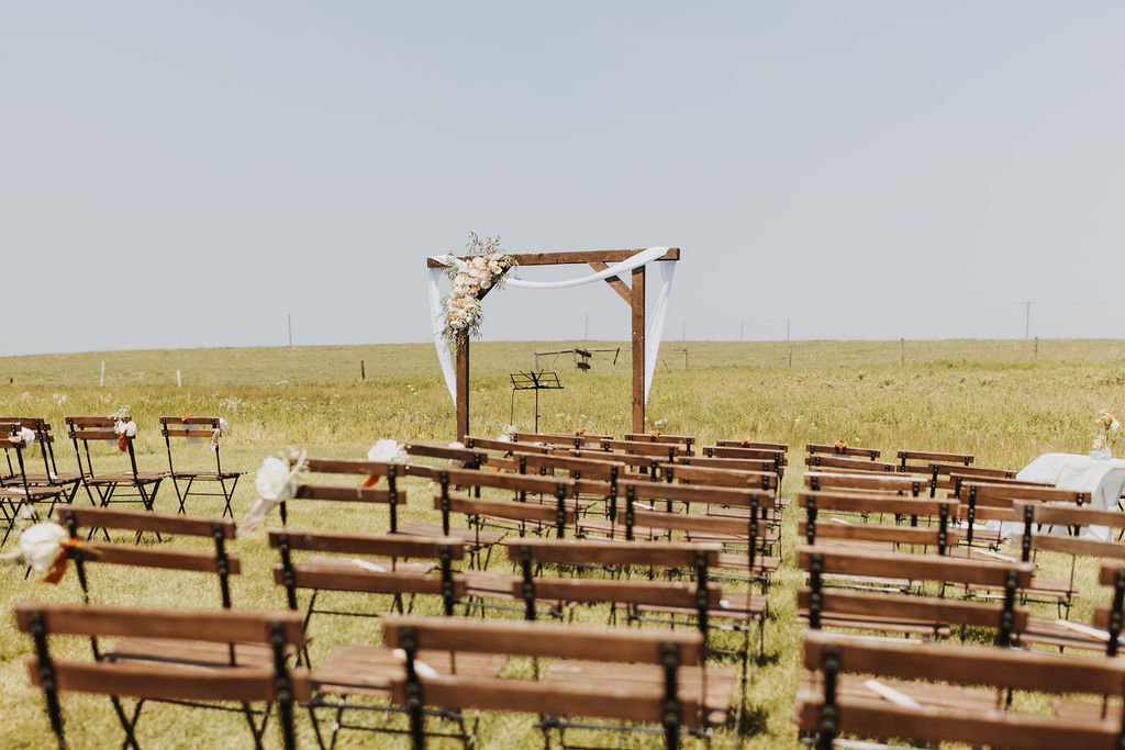 An outdoor wedding ceremony set up in a field.