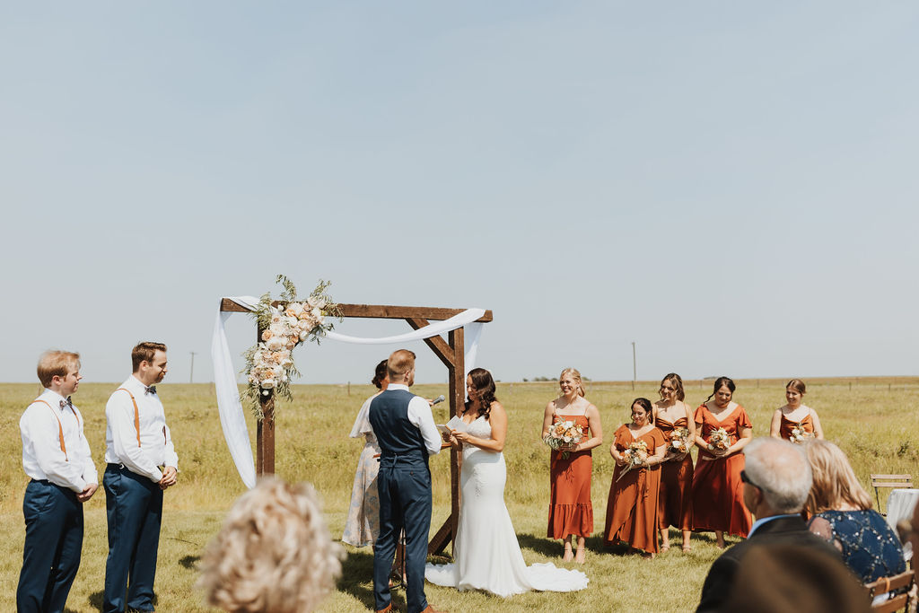 A wedding ceremony in the middle of a field.