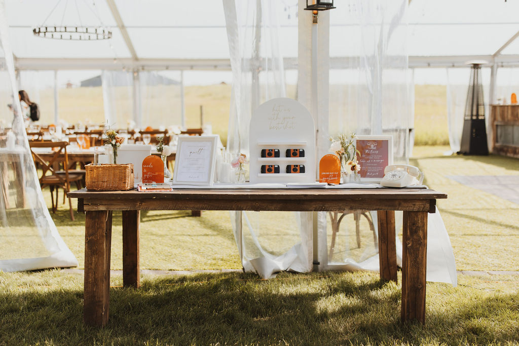 A welcome table set up outside a wedding tent. Outdoor Dinner Party