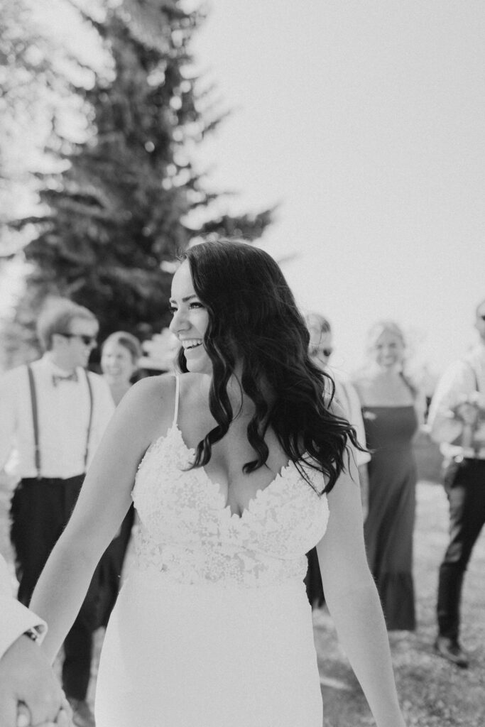 Black and white photo of bride and groom walking down the aisle.