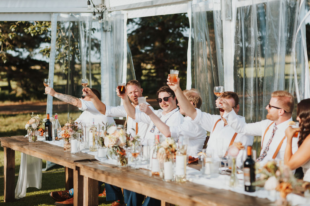 A group of people toasting at a wedding reception.