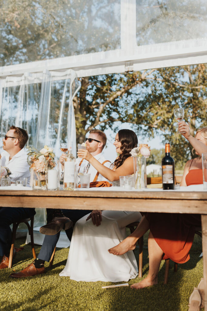 A group of people sitting at a table drinking wine.