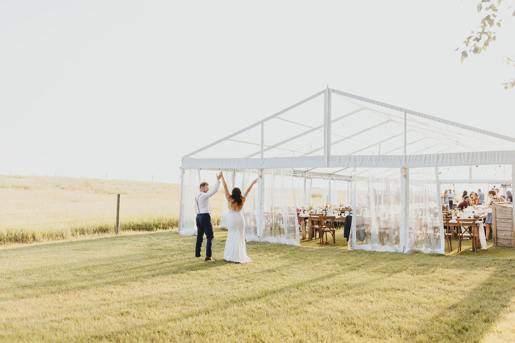 A bride and groom dancing in front of a clear outdoor wedding tent. Enchanting Outdoor Dinner Party