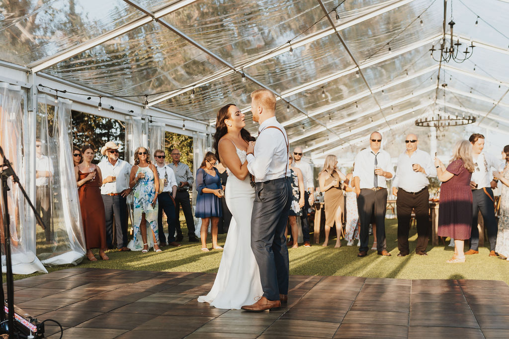 A bride and groom share their first dance in a tent. Enchanting Outdoor Dinner Party