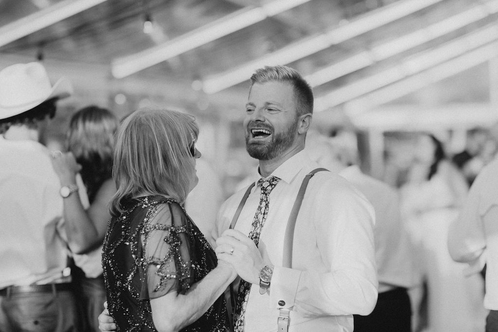 A black and white photo of a mother and son dancing at a Enchanting Outdoor Dinner Party wedding. 