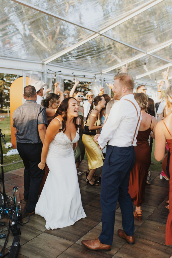 A bride and groom dancing on the dance floor at a wedding. Enchanting Outdoor Dinner Party