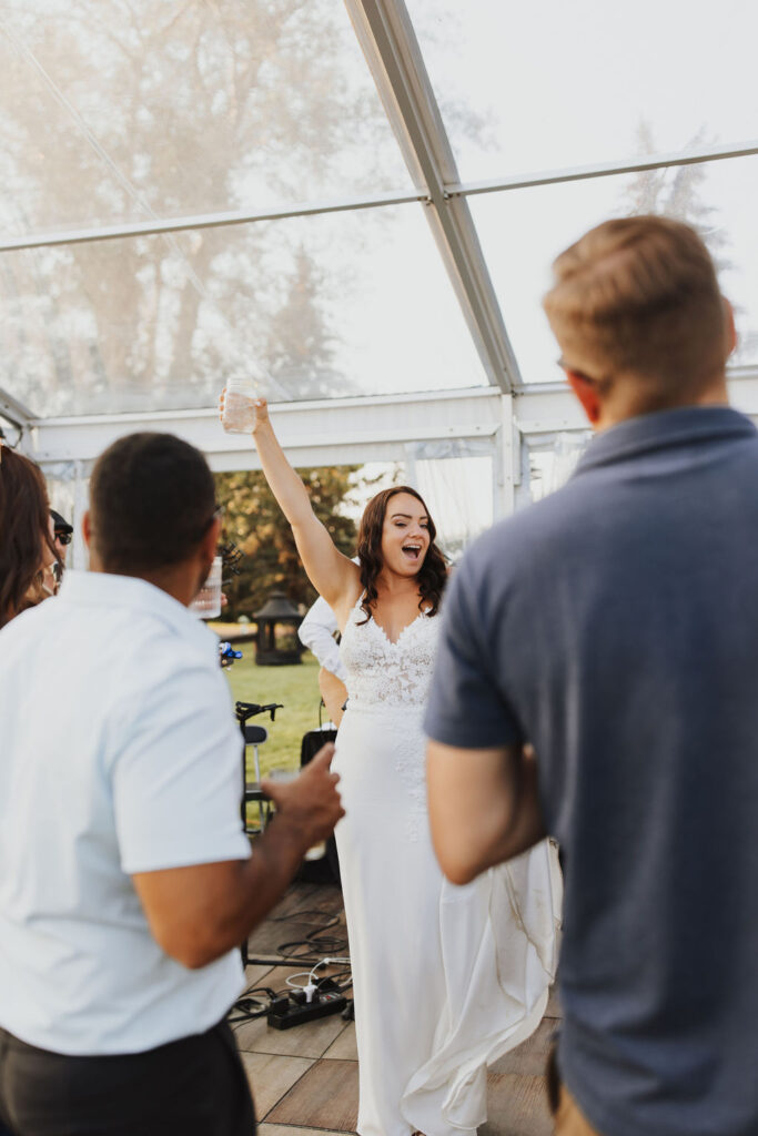 A bride and groom dancing in a tent at a wedding. Enchanting Outdoor Dinner Party