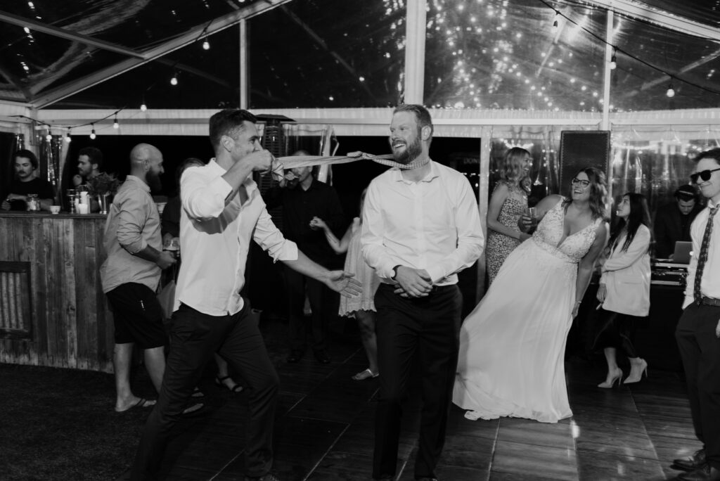 A bride and groom dancing on the dance floor at a wedding.