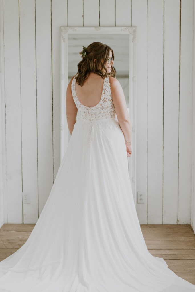 Back view of a bride in a white wedding dress.