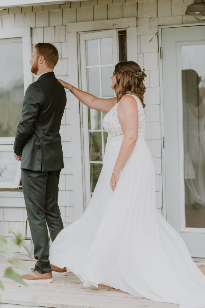 A bride and groom preparing for their first look on the porch of the bridal cottage at the Gathered in Calgary, Alberta. 