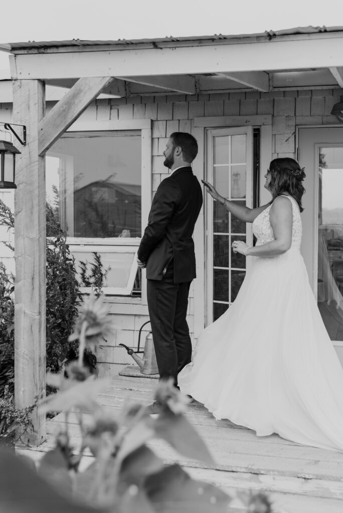 A bride and groom preparing for their first look on the porch of the bridal cottage at the Gathered in Calgary, Alberta. 
