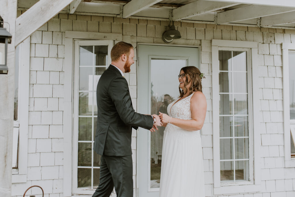 A bride and groom at their first look on the porch of the bridal cottage at the Gathered in Calgary, Alberta. 
