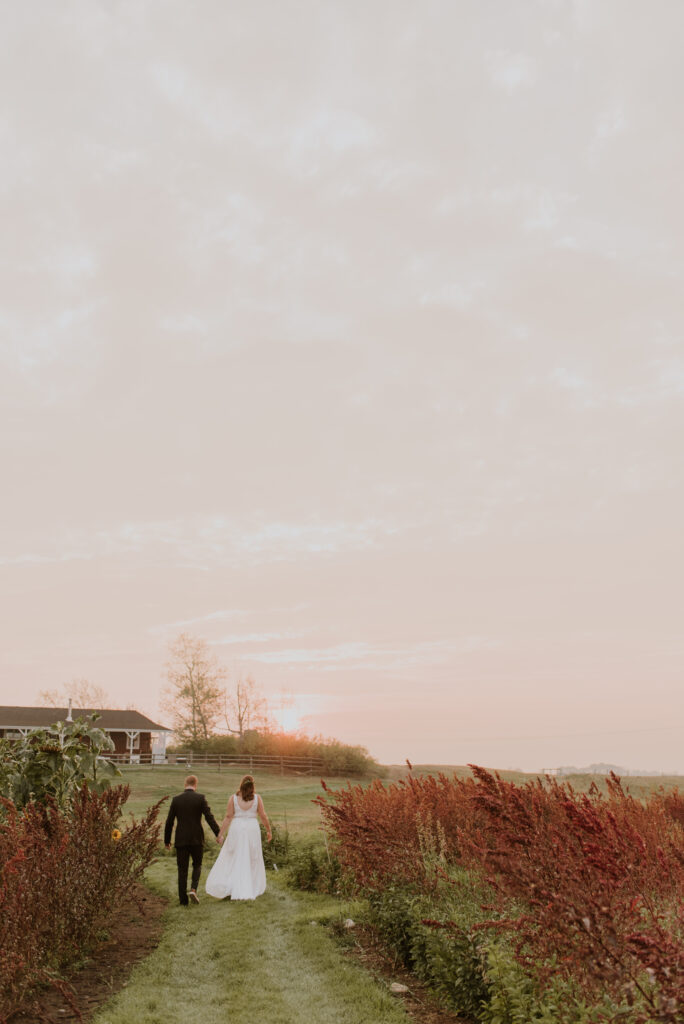 A man and woman walking in a field.