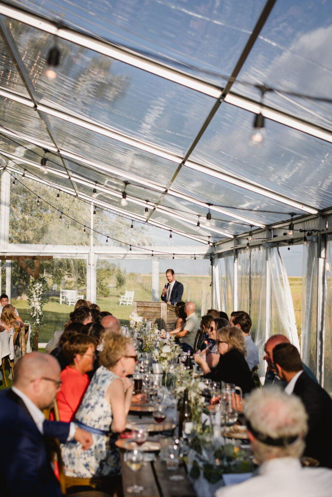 A wedding reception in a glass tent.