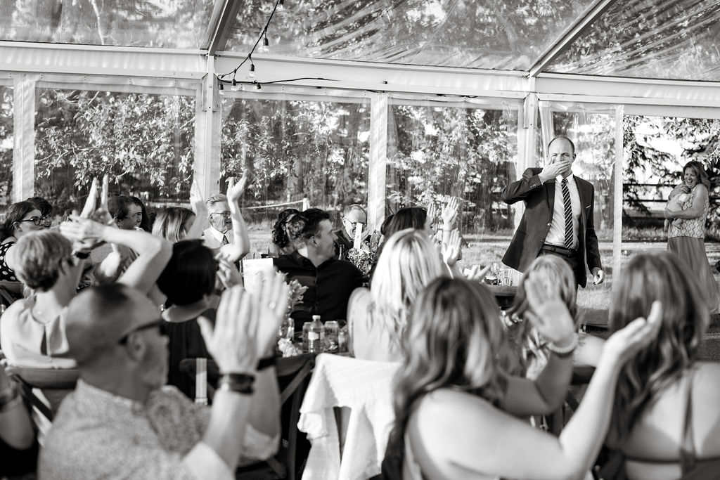 A black and white photo of a group of people at a wedding.