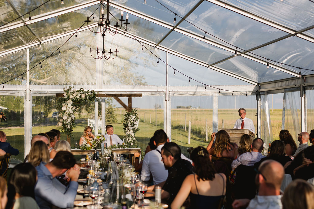 A wedding reception in a large tent.