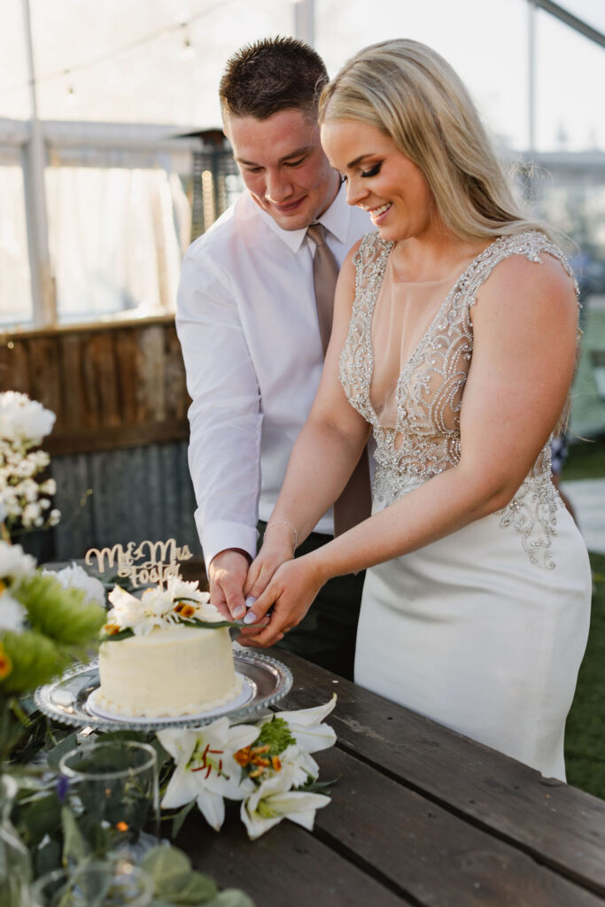 A bride and groom cutting their wedding cake. diy florals