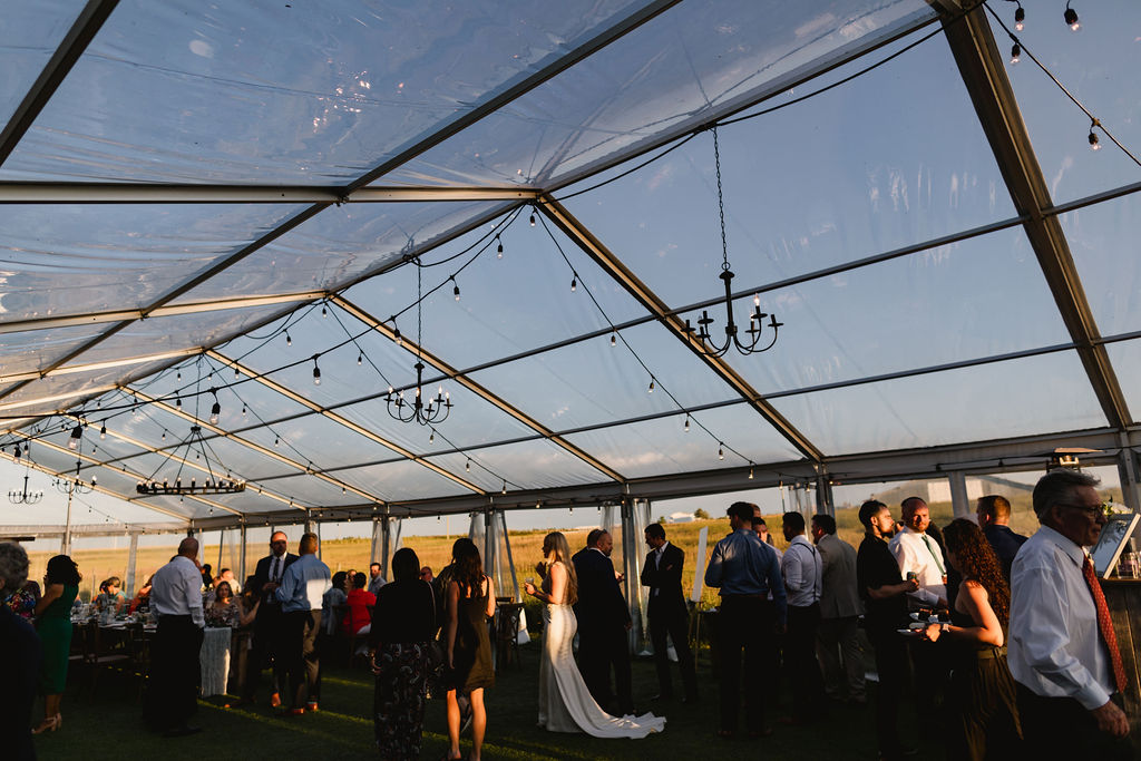 A wedding reception in a large tent.