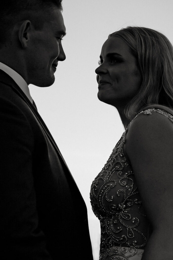 A black and white photo of a bride and groom looking at each other.