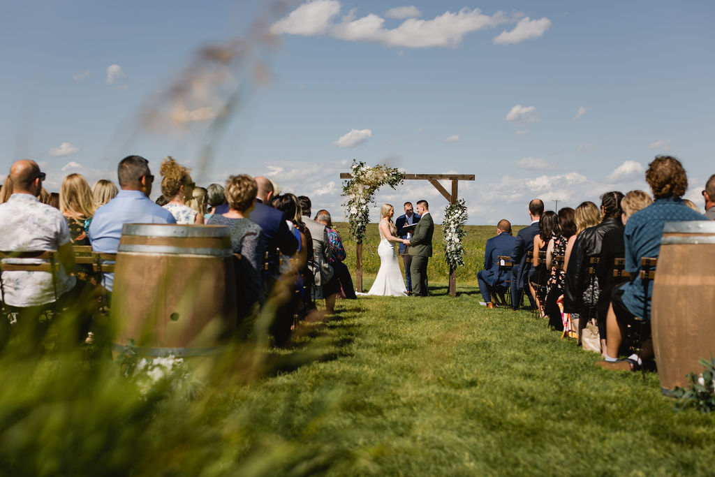 A couple getting married at an outdoor wedding.